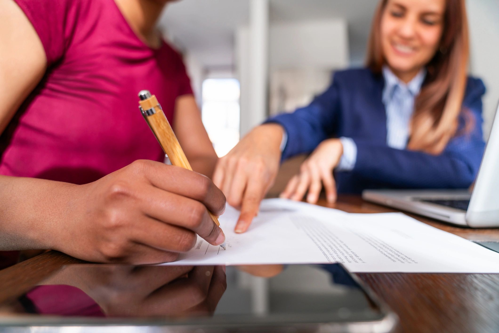Client signing important legal documents during a consultation