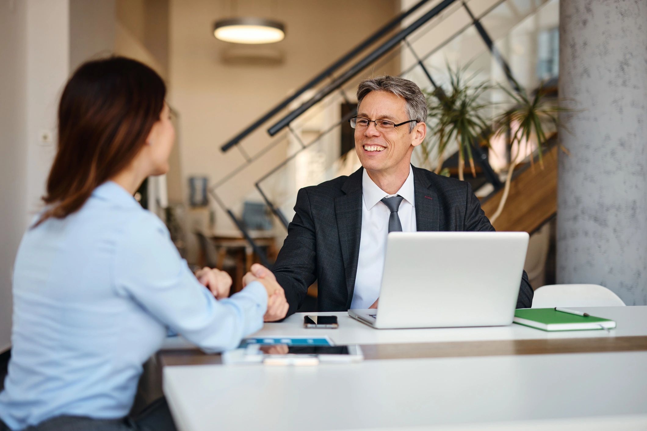 Professional handshake representing legal resolution and client trust